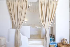 two curtains in a bathroom with a tub at La Maison Blanche in Agios Stefanos +98 photos