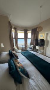 a bedroom with a large bed with a view of the ocean at Dacara Bed & Breakfast in Newcastle