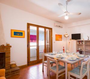 a dining room with a table and chairs and a fireplace at La Casa di Teresa in Scalea