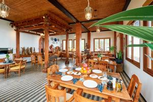 a dining room with a table and chairs at Villa Kampung Kecil Beach Front in Kubu