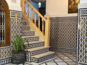 a staircase in a building with tiled floors and a stair case at Riad AYA in Rabat