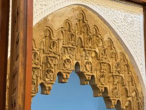 an arch at the entrance to a temple at Riad AYA in Rabat +97 photos