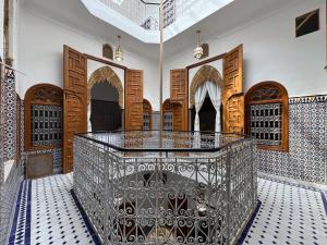 a room with a gate and wooden doors at Riad AYA in Rabat