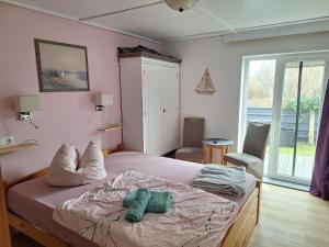 a bedroom with a bed with two pillows on it at Pension zum Meer in Breege