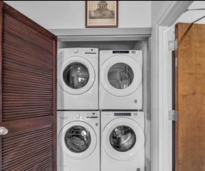 three washing machines and a washer and dryer in a room at Germantown Inn & Lounge in Hermann