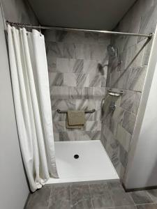 a bathroom with a shower with a shower curtain at Germantown Inn & Lounge in Hermann