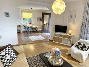 a living room with a couch and a tv at La Margaritta by Fewotessin in Minusio