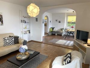 a living room with a couch and a table at La Margaritta by Fewotessin in Minusio