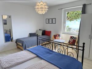 a bedroom with two beds and a chandelier at La Margaritta by Fewotessin in Minusio