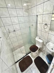 a bathroom with a shower and a toilet and a sink at Anexo Térreo - Pousada Cannã in Recife