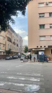 a street with cars parked in front of a building at Batman in Taza