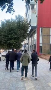 a group of people walking down a street at Batman in Taza