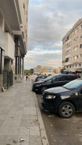 a row of parked cars in a parking lot at Batman in Taza