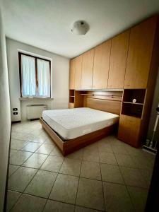 a bedroom with a large bed and a window at Volpes home in Desenzano del Garda