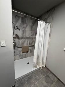 a bathroom with a shower with a shower curtain at Germantown Inn & Lounge in Hermann