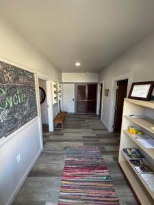 a hallway with a chalkboard on the wall and a rug at Germantown Inn & Lounge in Hermann