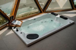 eine Badewanne vor einem Fenster in der Unterkunft Ishak Glamping in Tequila