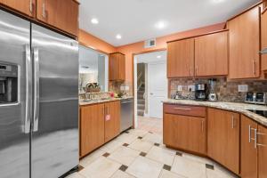 a kitchen with wooden cabinets and stainless steel appliances at 803 Clipper Court in Hilton Head Island
