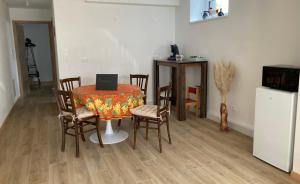 a dining room with a table with chairs and a laptop on it at Le Charme de Colmar B&B in Colmar +20 photos