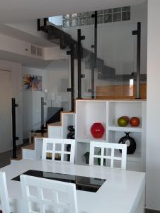 a kitchen with a white table and white chairs at Casa Diego in Alcañiz +14 photos