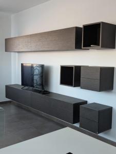 a living room with black furniture and a fireplace at Casa Diego in Alcañiz
