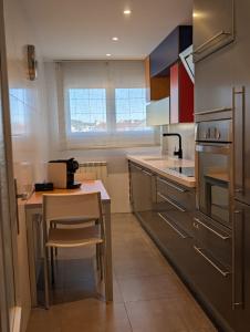 a kitchen with a counter and a table in it at Casa Diego in Alcañiz