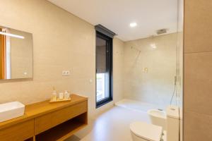 a bathroom with a toilet and a sink and a shower at Casa Da Luz in Lousada +27 photos