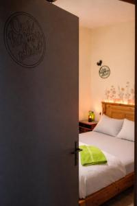 a bedroom with a bed and a door with a green pillow at Moroccan Place Private Room in Agadir