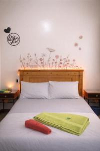 a bed with a green towel on top of it at Moroccan Place Private Room in Agadir