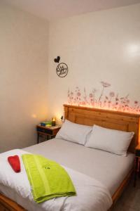a bedroom with a bed with a green towel on it at Moroccan Place Private Room in Agadir