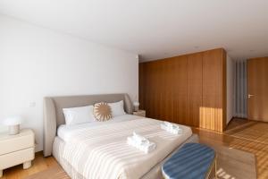 a bedroom with a large bed and a wooden cabinet at Casa Da Luz in Lousada