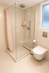 a bathroom with a shower and a toilet at Terranova beach apartment -Rose in Ipsos +22 photos