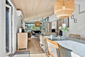 a kitchen and dining room with a table and chairs at 2613-Romo-Sneppen-7 in Høm
