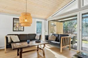 a living room with a couch and a table at 2613-Romo-Sneppen-7 in Høm +27 photos
