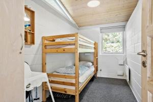a bedroom with bunk beds in a tiny house at 2613-Romo-Sneppen-7 in Høm