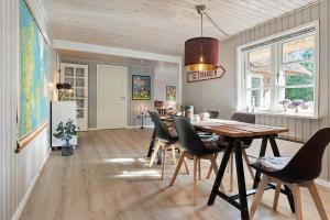 a dining room with a table and chairs at 2010-Romo-Moritzvej-10 in Høm
