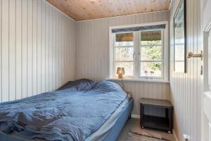 a bedroom with a bed and a television in it at 2010-Romo-Moritzvej-10 in Høm