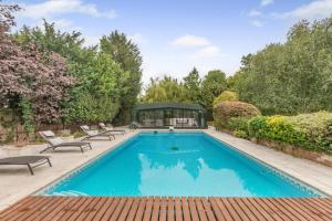 a swimming pool with chairs and a gazebo at 4 Bed in Bray oc-b32610 in Bray