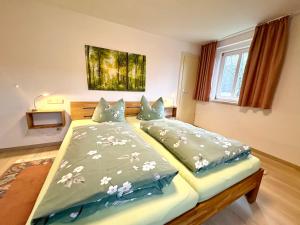 a bedroom with a large bed with two pillows at Landhaus Büttner Altenberg, zentral, familienfreundlich, Skihang & Erlebnisberg fußläufig in Kurort Altenberg
