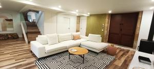 a living room with a white couch and a table at ACASADETEO in Padrón