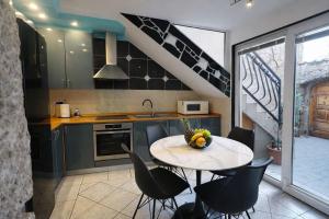 a kitchen with a table with chairs and a sink at Apartman Lucija in Selce
