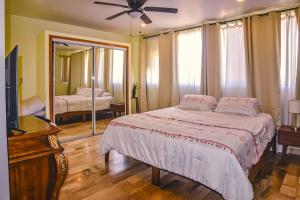 a bedroom with a bed and a tv and a mirror at Stylish Apartment Upscale Chapultepec District in Tijuana