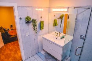 a bathroom with a sink and a shower at Stylish Apartment Upscale Chapultepec District in Tijuana +138 photos