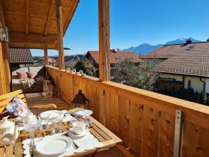 a table on the balcony of a house at CHIEMSEE MOUNTAIN LODGE - adults only - Eleganz auf 95qm - Traumblick - XL-Balkon - Privatsphäre in Bernau am Chiemsee