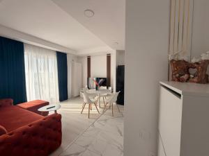 a living room with a couch and a table at Damon Suite #NorthBucharest in Tunari