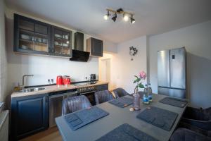 a kitchen with a table with chairs and a kitchen with a tableablish at Helles Apartment in bester Lage in Landshut
