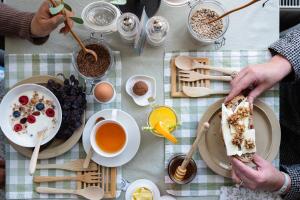 a table topped with plates of breakfast food and drinks at De Roos Leeuwarden Bloementuin & Biodynamisch Ontbijt in Leeuwarden