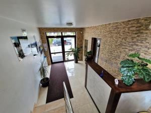a hallway with plants and a brick wall at Bella Vista Bungalow in Turda