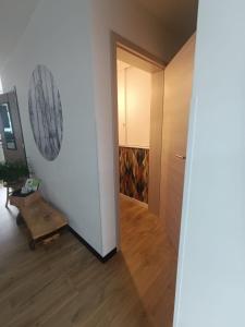 a hallway with a door leading into a room at Au Coin du Bois in Manhay +26 photos