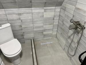 a bathroom with a toilet and a shower at Glola A-Frame Cottages in Glola +17 photos